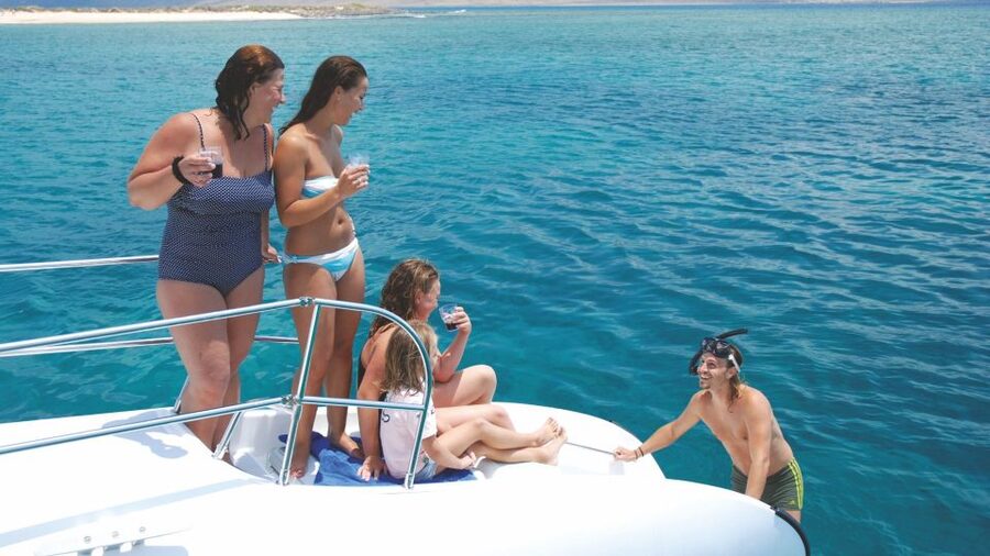 From Lanzarote: Sailing Day Trip Around La Graciosa - Boarding the catamaran: champagne, shoe rules, and on-board reality